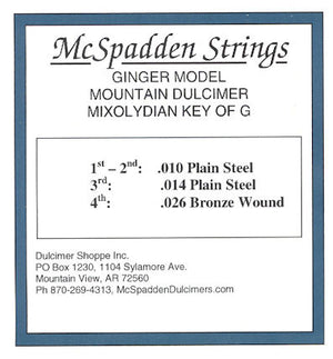 Label for McSpadden Strings' Ginger Model Mountain Dulcimer in Mixolydian Key of G, featuring the Ginger Key of G String Set BALL End with precise gauges: .010, .014, .014 Plain Steel, and .026 Bronze Wound. Company contact information is provided at the bottom.