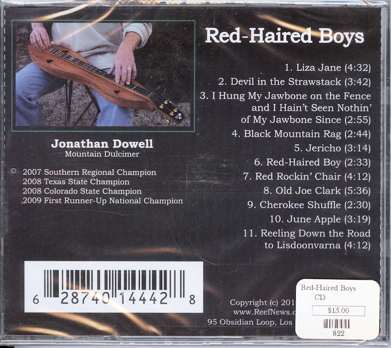 The CD cover for "Red-Haired Boys" by Jonathan Dowell displays a song list and a photo of an individual playing a mountain dulcimer, along with a visible price sticker.