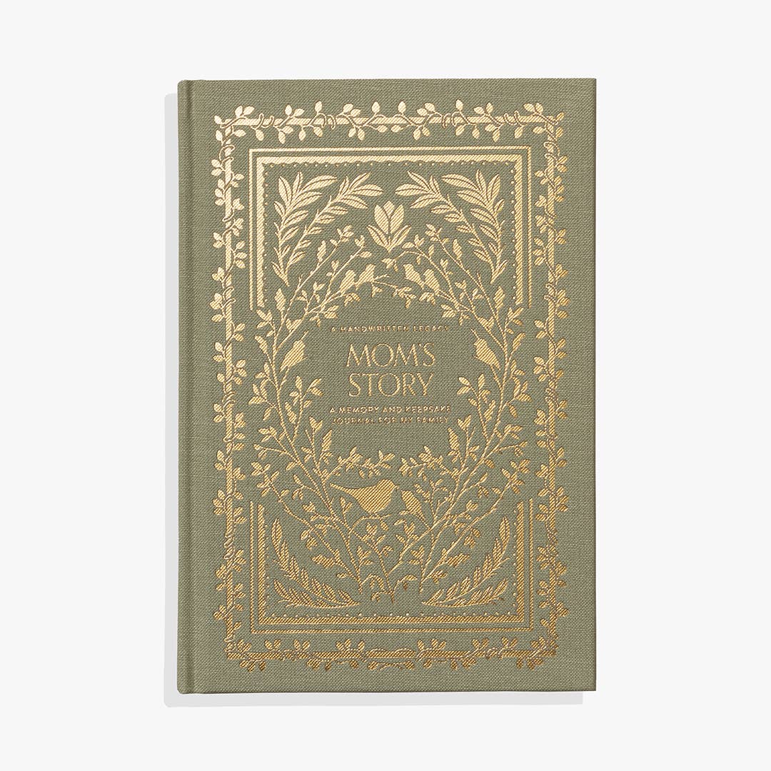 A green and gold guided journal with the words "Mom's Story" on it.