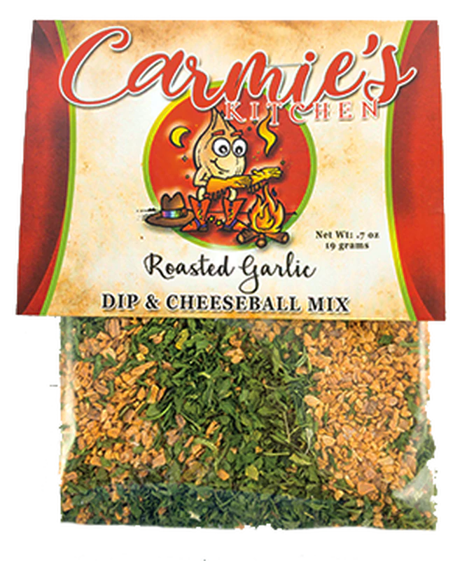The Carmie's Kitchen Roasted Garlic Dip Mix packaging showcases a cheerful cartoon chef, while a clear section reveals the enticing blend of herbs and spices, emphasizing the delicious appeal of their dip mixes.